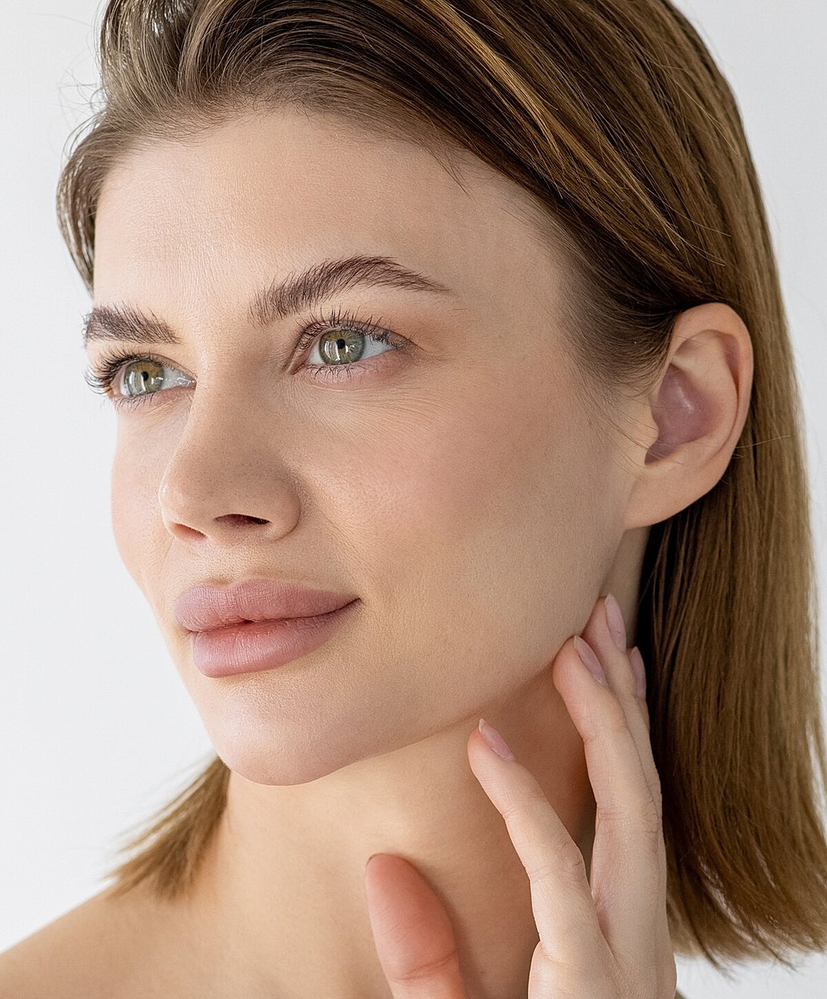 Close-up of a woman resting her chin on hands.