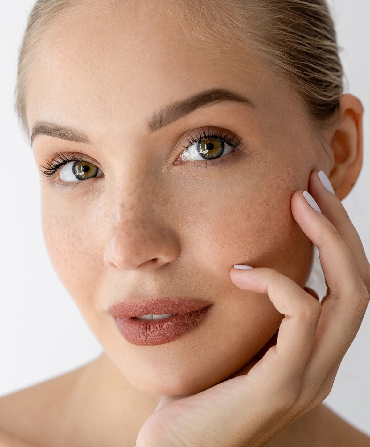 Close-up of a woman with freckled skin.