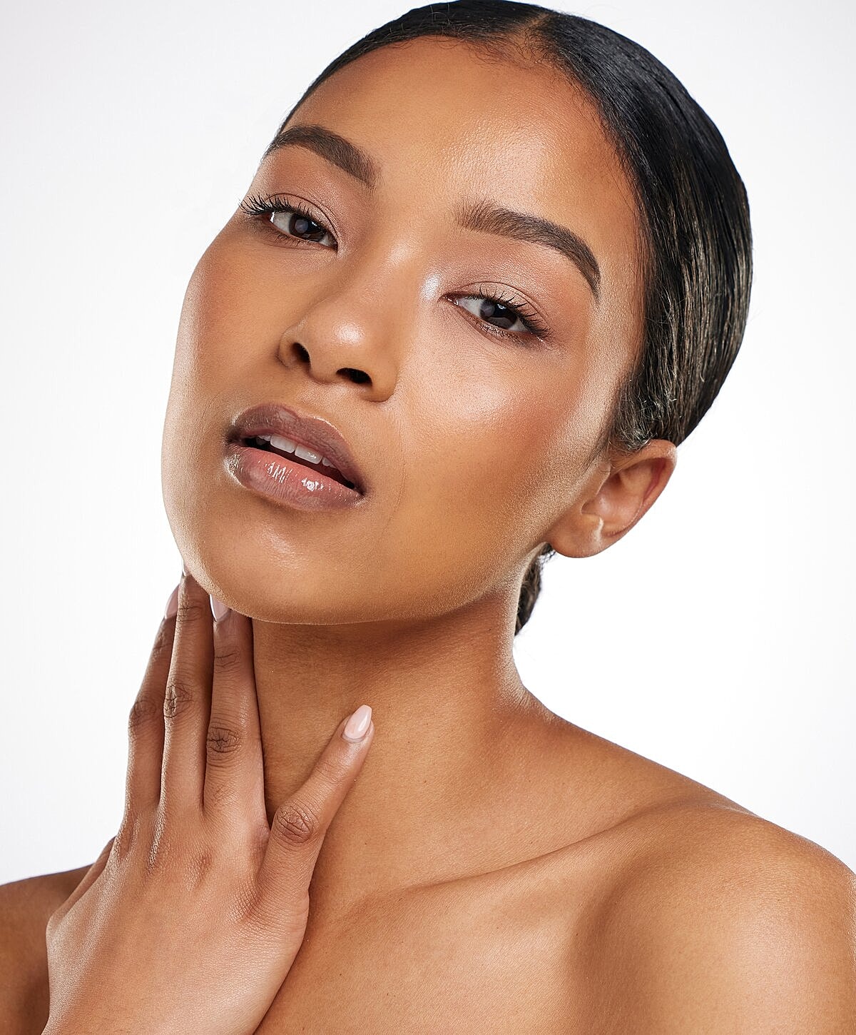 Woman with natural makeup and glowing skin.
