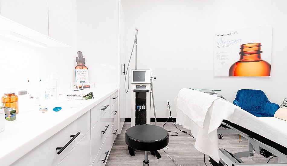 Modern skincare treatment room with equipment.