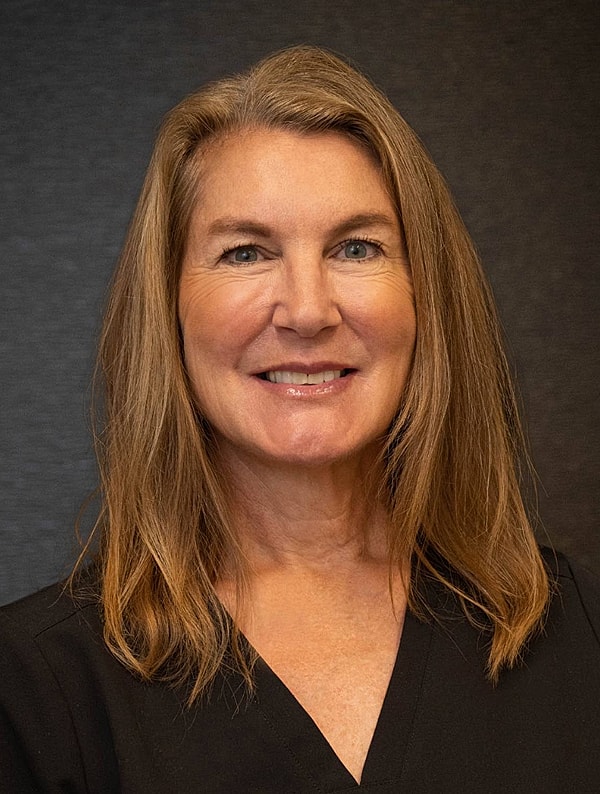 Smiling woman with long hair and black top